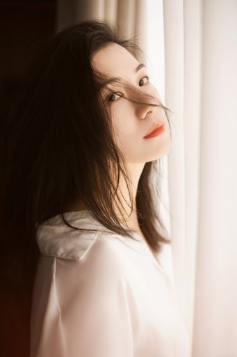 A closeup portrait of a beautiful dark hair white East Asian woman