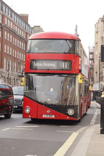 A vertical shot of a beautiful famous transportation red bus in London, United Kingdom