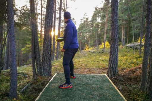 A person playing disc golf in a park