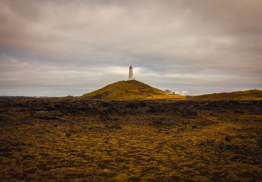 A scenic view the Reykjanes Lighthouse on a hill in Iceland