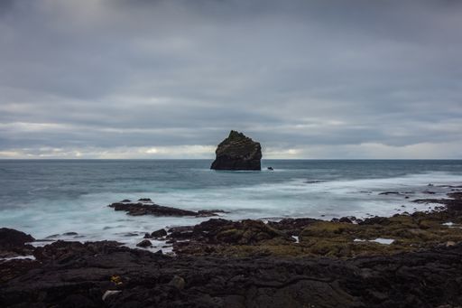 A natural view of the rocky coast and cliffs of Reykjanes in Iceland with long exposure