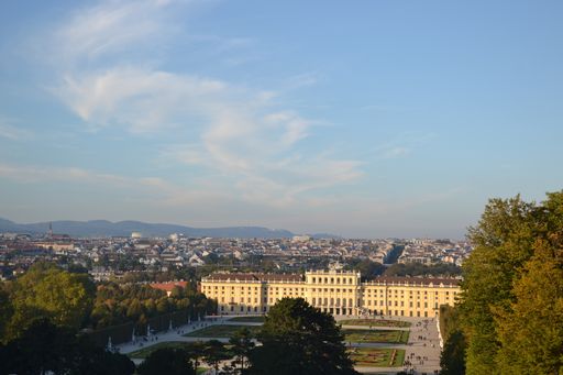 A high angle shot of Schloss Schonbrunn, over a background of the buildings of Vienna, Austria