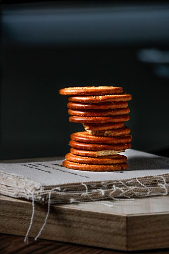 A closeup shot of fresh cookies stacked on top of each other on the book