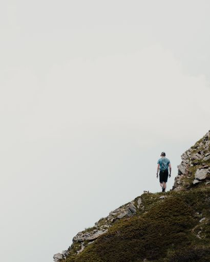 A man with backpack hiking in mountains