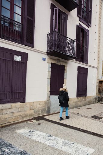 A vertical shot of a female walking on the streets of Ax-les-Thermes, France