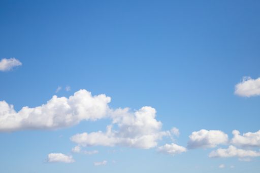 Bright blue sky with many beautiful white clouds for background or wallpaper