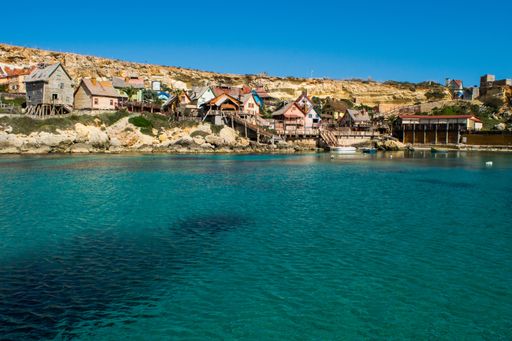 Popeye Village, colourful wooden huts and shacks used as a film set for Popeye film at Anchor Bay, Malta, now amusement park, on a sunny winter day.