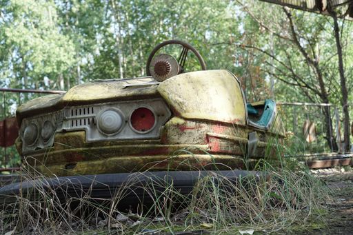 A closeup of an old yellow damaged bumper car at an amusement park of Pripyat ghost city