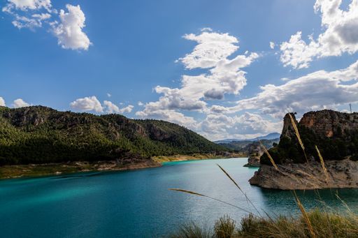 An amazing shot of a lake in a mountain landscape on a cloudy sky background