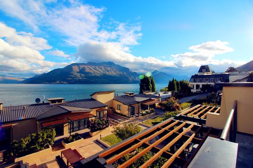 A beautiful view of lake Como behind buildings in background of mountains