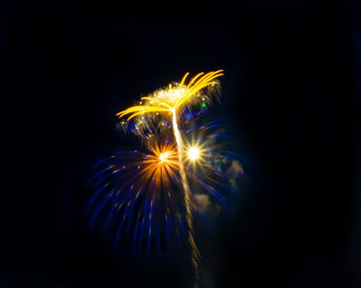 A view of fireworks in different colors glittering in the night sky creating a festive mood