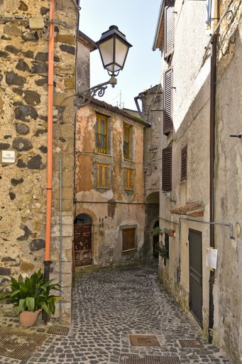 A vertical shot of a narrow street in Giuliano di Roma, a village in the Lazio region of Italy