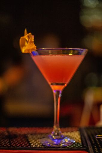 A vertical closeup shot of a glass of cocktail on the table