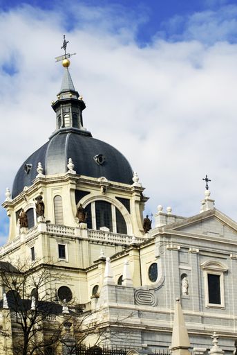 A vertical picture of mesmerizing Almudena Cathedral under the great sky in Madrid, Spain