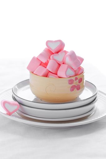 A vertical shot of pink marshmallows on the white background