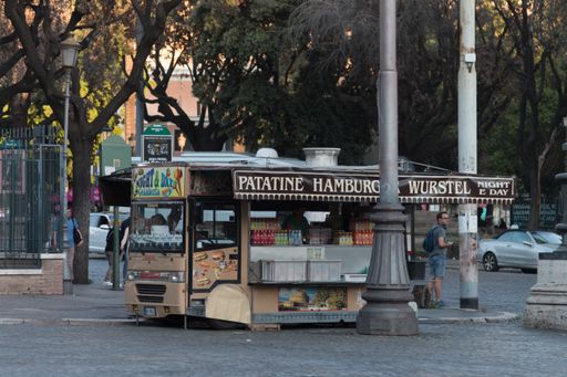 A small shop selling fast food in the streets of Rome, Italy on a beautiful evening