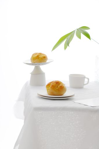 a vertical shot of cupcakes on white table isolated in white