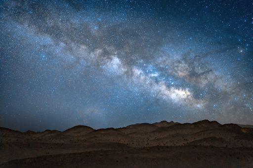 A long-exposure shot of a star trail over a deserted area