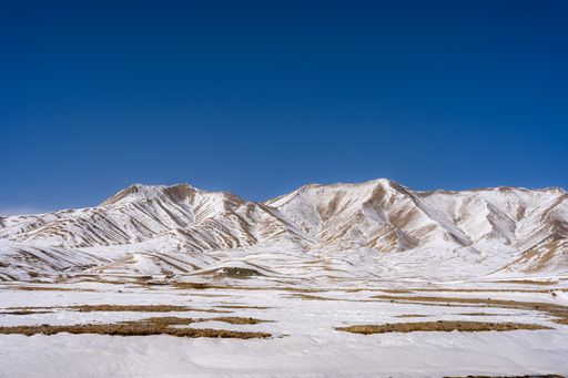Beautiful snowy mountains against a clear cloudless sky on a sunny day