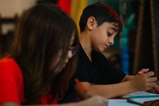 A selective focus of two children doing their homework