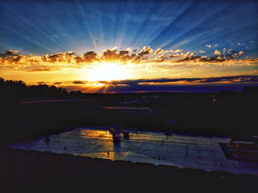 A scenic view of a majestic sunset with expressive sunbeams