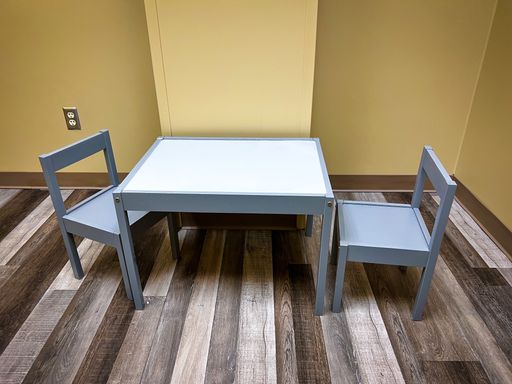 A view of kids table and chairs in cozy setting