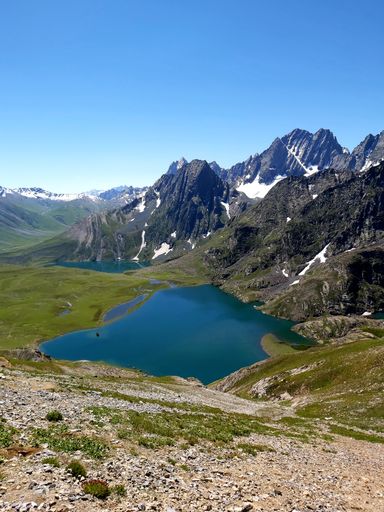 a vertical shot of lake surrounded by mountains