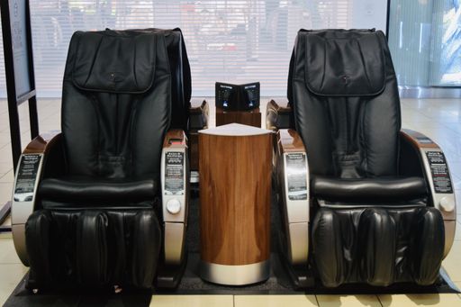 Two black massage chairs in the shopping mall