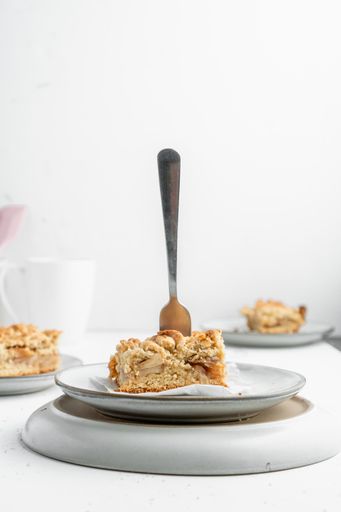 A vertical shot of a piece of crispy pie in a plate on the table