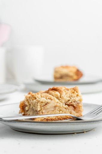 A vertical shot of a piece of crispy pie in a plate on the table