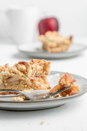 A vertical shot of a piece of crispy pie in a plate on the table