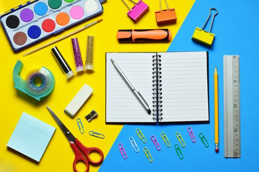 a top view shot of Zenith view  On yellow and blue bicolor background, various school supplies, education and learning.