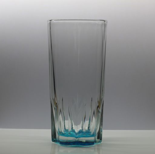 A transparent drinking glass isolated on a grey background