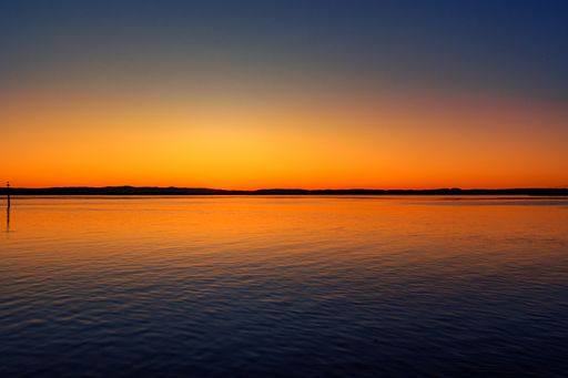 A breathtaking scenery of the sunset sky reflecting in the peaceful sea