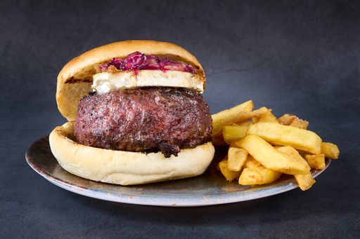 a close up shot of The Blarney Burger with and french fries on side in a plate.