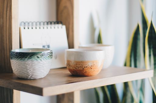 The aromatic candles on a wooden shelf