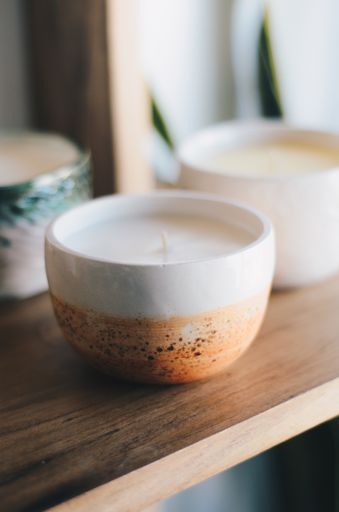 The aromatic candles on a wooden shelf