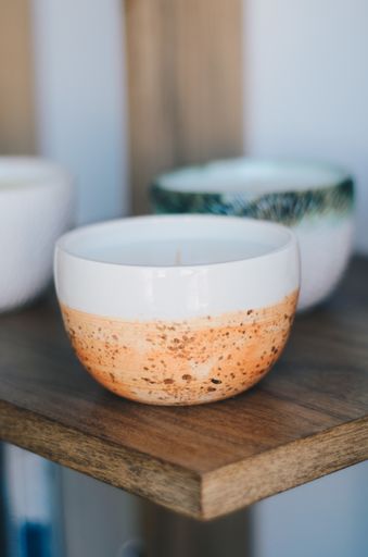 The aromatic candles on a wooden shelf