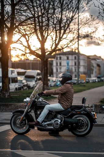 A young motorcyclist on a big motorcycle during the sunset in Munich
