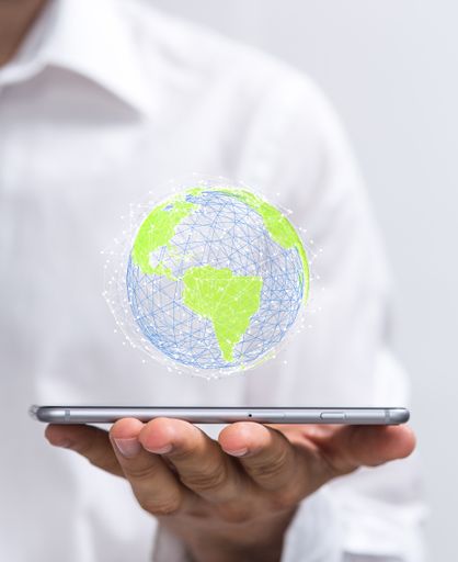 A green 3D planet with recycle icon hovering on a man's phone