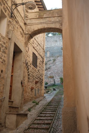 A vertical shot of the narrow street in Assisi. Italy.