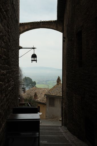 A vertical shot of the narrow street in Assisi. Italy.