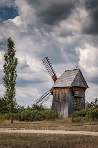 A vertical shot of a 19th-century windmill in Tokarnia near Kielce, Poland