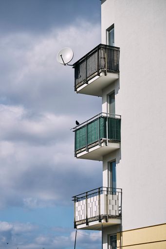 A vertical shot of three balconies of an apartment building in the Stare Zegrze district. Poznan.