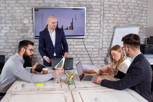 A group of successful young business partners having a meeting and discussing new business project ideas in an office - startup business concept