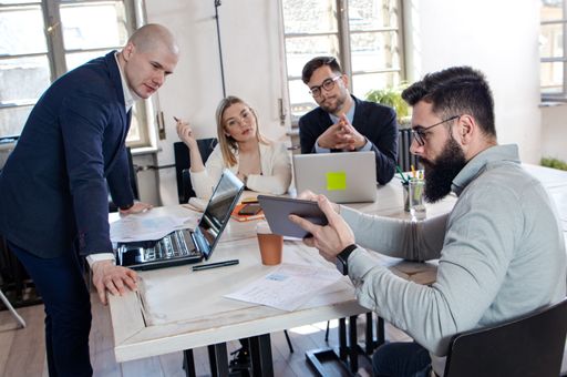 A group of successful young business partners having a meeting and discussing new business project ideas in an office - startup business concept