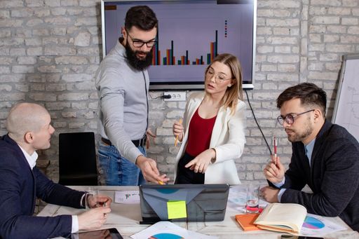 A group of successful young business partners having a meeting and discussing new business project ideas in an office - startup business concept