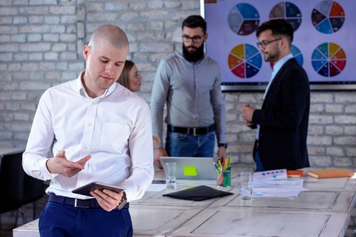 A group of successful young business partners having a meeting and discussing new business project ideas in an office - startup business concept