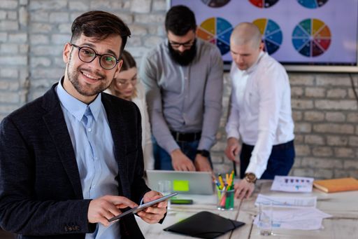 A group of successful young business partners having a meeting and discussing new business project ideas in an office - startup business concept
