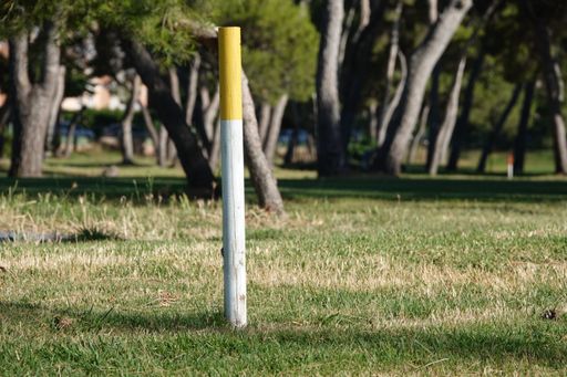 A selective focus shot of a golf course without a flag in golf field